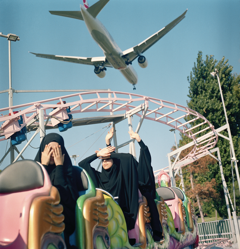 A plane flies low over students at an amusement park, Istanbul, 2018
